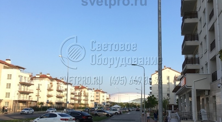 На фото изображена опора, установленная на территории жилого комплекса. Обратите внимание, что между осветительными конструкциями отсутствуют провода. Силовые линии прокладываются под землей, поэтому надежно защищены от обрывов и не портят внешний вид места проживания людей. 