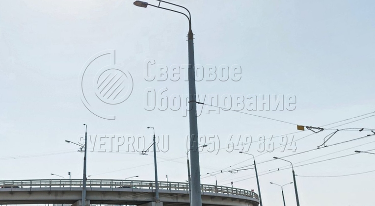 Граненая опора для контактной сети может выдержать большую нагрузку. Поэтому к ней крепятся растяжки с контактными проводами и тяжелые светильники. На фото представлена опора с двумя световыми приборами на рожках, расположенных друг над другом. Они ярко освещают проезжую часть. 
